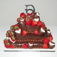 Chocolate Cheesecake With Tuxedo Strawberries Chocolate cheesecake with chocolate ganache glazing and tuxedo strawberries.