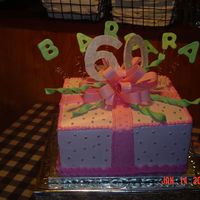 60Th Birthday Cake This is a marble cake iced with buttercreme frosting. It has fondant and gumpaste accents.