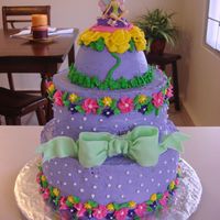 Tinkerbell I made this cake for a friends birthday party. The bow was made from fondant and the rest of the accents were made from buttercream icing....