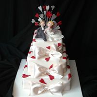 Shelley And Craig's Wedding Cake Three tiers of caramel mud, Boonenati's recipes, covered in Bakels pettinice and with a modelling paste bride and groom on top.