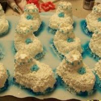 Baby Booties For A Bay Shower Boy Baby booties for a baby shower BOYit done with a regular sz cupcake and a mini with whipped cream icing.