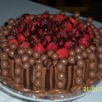 Grooms Cake chocolate lover dream has whopper and tootsie rolls on it grooms request the tootsie rolls are the falt strips, ropes, all rolled out with...