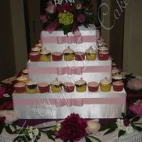 Amy This was a cupcake cake. The stand held about 50 cupcakes and the rest were placed in the cooler. The groom's father custom made this...