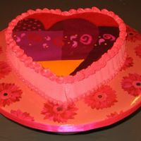 Img_1859_1_1.jpg Hazelnut cake with nutella mousse filling and vanilla Italian meringue buttercream frosting. The chocolate transfer on top is bordered by...