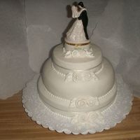 All White Wedding Cake This was my first wedding cake! Fondant, fondant ribbon roses. With this one I definitely learned LESS IS MORE.