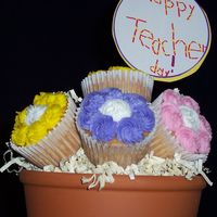 First Cupcake Bouquet Inspired by Cammie's forum post on her cupcake bouquets. Made for My son's teacher. Son made the sign! White cupcakes w/bc icing...