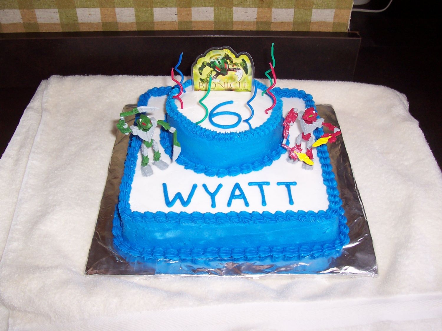 Bionicle Birthday Cake Chocolate cake with buttercream. Got the cake toppers on eBay. My son was obsessed with Bionicle this year!