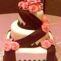 Shenita Sorry for the grainy photos; done w/ cell phone. For a friend, Fondant covered 6 x 10 rd x 12 sq. golden butter cake w/ creme bouquet...