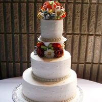 Terracotta Wedding Buttercream, gumpaste flowers and leaves and ribbon fillers.