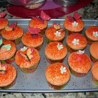 Baby Shower Papaya RI topped (rum cake) cupcake with fondant flowers and RI butterflies.