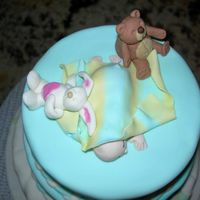 Sleeping Baby With Dolls This is the top of a baby shower cake. All fondant.