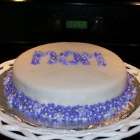 Simple But Sweet Flower Cake I made simple sugar drop flowers in different shades of violet and attactched them around the bottom of the cake. I also wrote mom on the...
