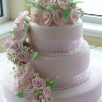 013.jpg This was one of my first Wedding Cakes. I made a lot of the Roses myself and mixed them in with some gumpaste sprays that I bought.