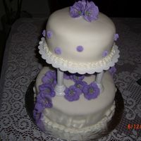 Fondant Cake With Purple Flowers Final class cake from Wilton Course III.