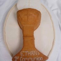 First Communion Cake I cut out the challis and host and layered them on top of an oval layer. I used buttercream and gold dust to decorate.