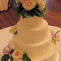 7/7/07 Wedding Cake fondant pleats, cornelli lace, swiss dots with silver dragee accents, basketweave. fresh flowers
