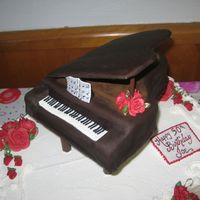Grand Piano i carved the piano shape from a 9" square. the lid is fondant covered cardboard. the legs are 7" push-in pillars painted with...