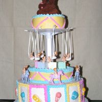 Baby Shower This cake was done a year ago. Based on the Wilton cake. All buttercream and candy molds. The babies, blocks and rocking horses are the...