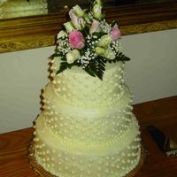 Anniversary Cake Lemon cream cheese frosting over a white cake. Fresh flowers on top.
