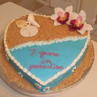 7Th Anniversary Cake For Beach Lovers Heart-shaped anniversary cake for a beach-loving couple. Single layer white chocolate macadamia nut cake with vanilla buttercream frosting...