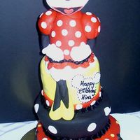 Minnie Mouse Topsy Turvy This cake is a Disney/Minnie Mouse themed topsy turvey cake. The minnie mouse was made in advance and is styrofoam covered in fondant. I...