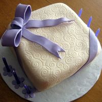 Tracy's Present Cake This was a fondant cake the I made for a friend. I used an impression mat for the scroll work.