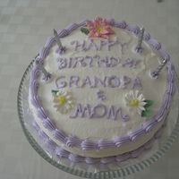 A Flower Birthday Cake I made this cake for my mom's birthday. The flowers were made in my Wilton Course 2, they are royal icing