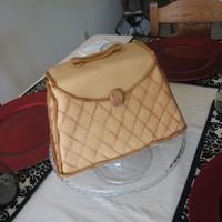 Leather Box Purse Vanilla cake with french vanilla buttercream.I was going for a quilted leather effect with the fondant.