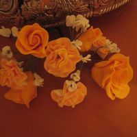 Orange Flowers My first gumpaste flowers. A mix of carnations, roses, and baby's breath. Ty for looking!