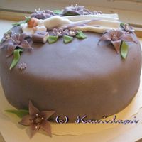 Christening Cake For A Girl Called Lila Covered with a marzipan and all the flowers and baby is also mostly marzipan or sugarpaste.