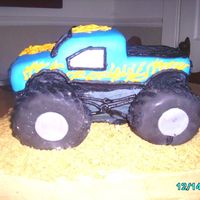 Monster Truck this cake was for a little boys 1st bday. monster truck with flames. cake and truck was yellow cake and the tires were donuts covered n mmf...