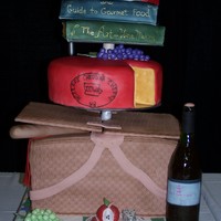 Food And Wine Expo Contest Cake This was a cake we did for the Premier Food and Wine Expo. Everything on the cake is 100% edible!! Basket, cheese, books are cake. Plates...