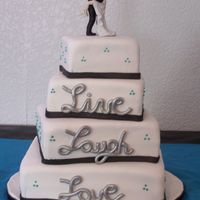 Live, Laugh, Love 4 tier off center square wedding cake. Live, Laugh, Love in gumpaste and airbrushed metallic silver.