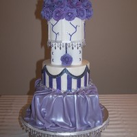 Purple Mixed Shape 3+ tier cake with "bump out" seperator tier. Edible hand sculpted roses