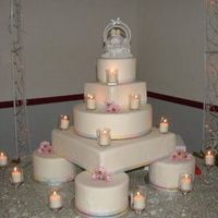 Precious Candlelit Moments This was one that I did this for my little brother's wedding in June. It's a multi-tiered display cake covered in white fondant...