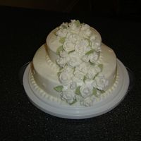 Course 3 Tiered Wedding Cake This was my first wedding cake. It was made for Wilton Course 3. It is a Lemon cake with buttercream icing and fondant roses.