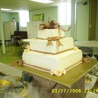 S4010310.jpg My first stacked wedding cake. Also my first shot at gumpaste roses and ribbons. I was a ball of nerves with this cake! It wasn't what...