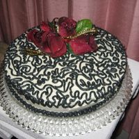 Dark Lace Small Anniversary cake for a family friend. Yellow cake w/ almond butter cream icing. Loved making it! :0)