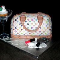 Purse I was so excited I finally got to make one of these. I used edible images for the pattern. The cellphone and lipstick are made from molding...