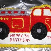 Firetruck Cake White cake made with the Wilton Fire Truck pan and frosted with Wilton colored icing (the kind sold in tubes).