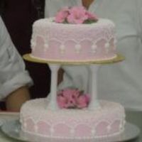 Graduation Piece...wilton Level 3 Top tier - butter & chocolate cake, bottom tier - butter/chocolate marble cake.Pink Petunia flowers and cornelie lace.