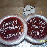 Engagement Cheesecake this was 2 cheesecakes made to look like wedding rings. the diamond is cookies. icing for the rings are sprayed with silver luster dust....