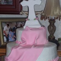 My Daughters Baptismal Cake cross is a ceramic gift that was given to her. pink fondant drape