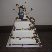 Malteser & Ivory 3 Tier Square cake, iced in Ivory with Chocolate & White Chocolate Malteser's and Marzipan Garda (Policeman) and his Bride... to...