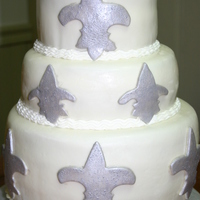 Flur De Les 3 tier white cake with buttercream and strawberry filling covered in mmf and painted with silver pearl dust