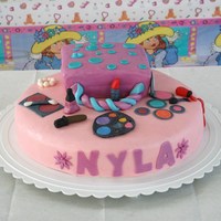 Makeup All Over My six year old wanted this cake, she made the spilled purse. The cake was strawberry cake with Buttercream covered in strawberry mmf.