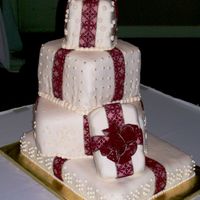Christmas Presents The wedding was the day after christmas and the bride wanted a cake that looked like stacked presents. I used real ribbon on fordant, the...