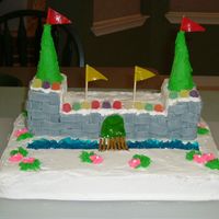 First Attempt At A Castle Cake Made several years ago for my 2nd grade class. The moat is blue jello. Cake is white cake with buttercream icing.