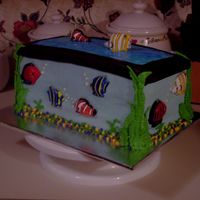 Aquarium Birthday Cake This is a 3-layer butter flavored Aquarium cake I made for a friends son. The fish are Wilton candles cut in half. The top is blue piping...