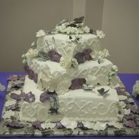 Wedding_Cake_April_5_004.jpg Fondant covered white cake with BC filling and gumpaste flowers and ricepaper butterflies.